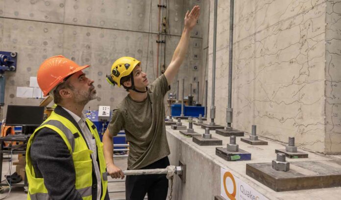 Professor Santiago Pujol (left) discusses the wall tests with PhD candidate Charlie Kerby at the Structural Engineering Laboratory at the University of Canterbury.