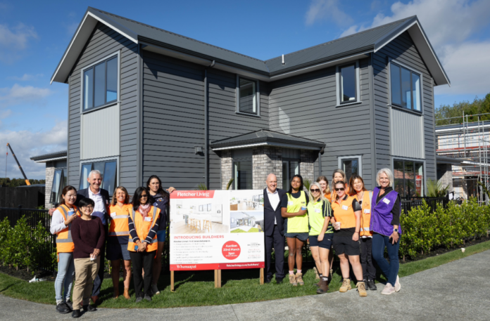 The BUILDhers crew with Prime Minister Chris Luxon and Fletcher Building chief executive Ross Taylor outside the completed house.