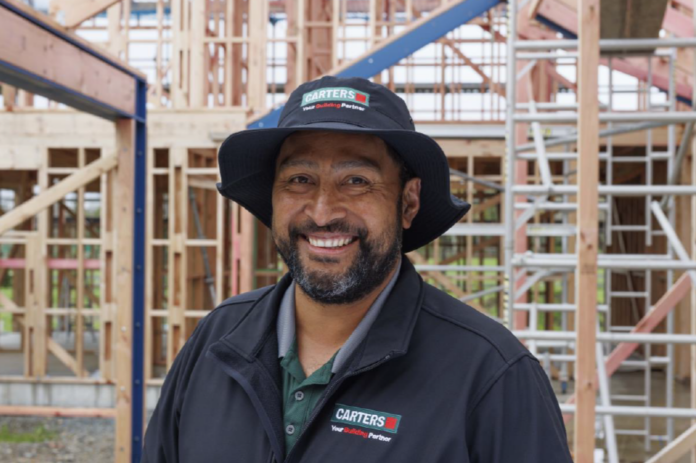 A Carters team member wears a wide brim hat for on-site sun protection.